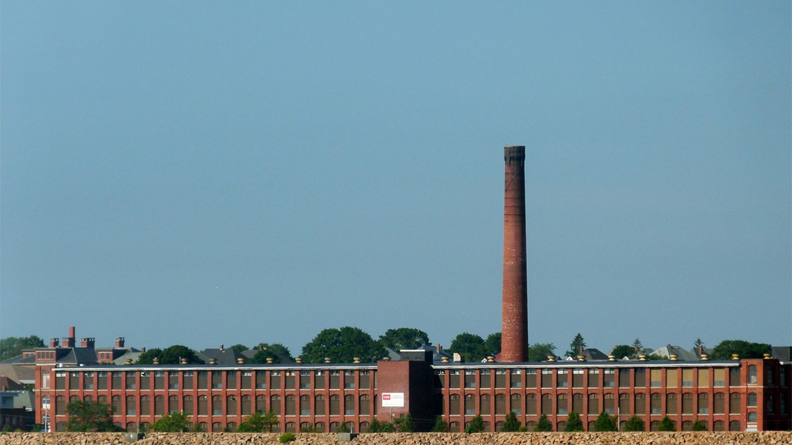 A brick mill building on the water in New Bedford, Massachusetts